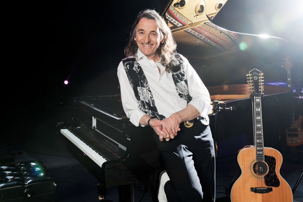 roger hodgson leaning on piano