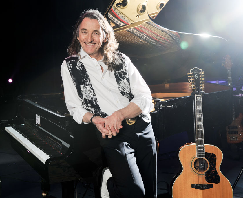 roger hodgson leaning on piano